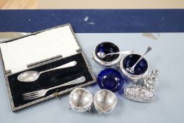 A pair of Victorian silver bun salts with blue glass liners and spoons, a spare liner, a later