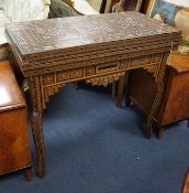 A 19th century Damascus mother of pearl, bone, and marquetry inlaid folding games table, with