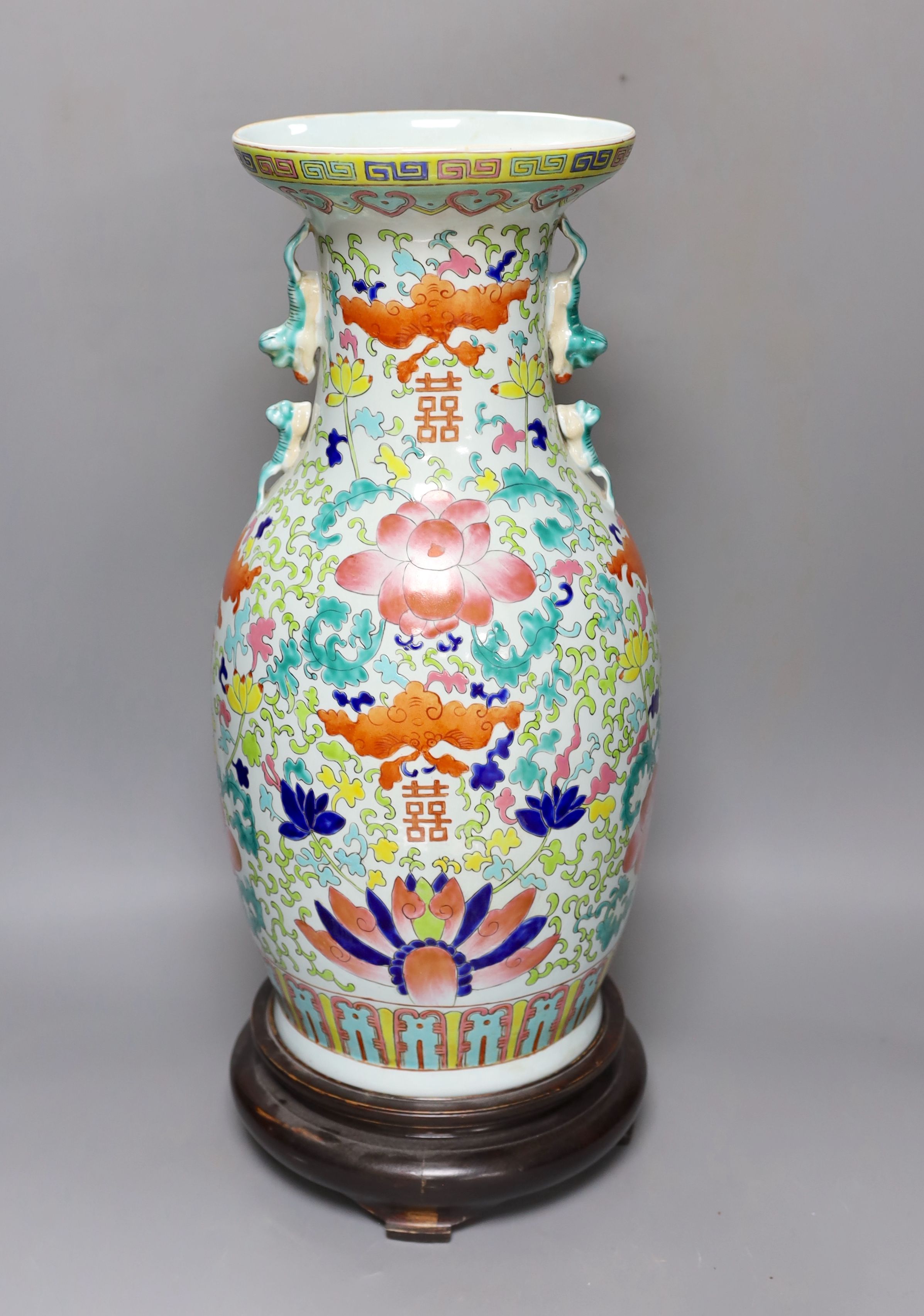 A large Chinese enamelled porcelain vase, on wood stand 53cm