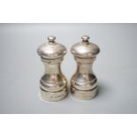 A modern pair of silver mounted salt and pepper mills, 10.4cm.