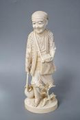 A Japanese carved ivory figure of a farmer, Meiji period, c.1900, signed, carrying a lantern on a