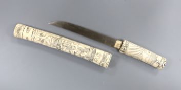 A Japanese carved bone tanto, c.1900, carved with numerous figures, overall 36cm