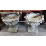 A pair of circular reconstituted stone garden planters moulded with acanthus leaves, diameter