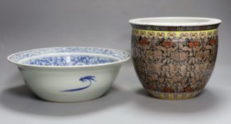 A 19th century Chinese blue and white basin and a famille rose jardiniere. Basin 29cm diameter