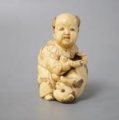 A Japanese ivory netsuke of boy and puppy, Meiji period, signed 4cm