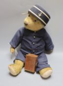 A Chiltern teddy bear dressed as railway porter, replaced footpads, thinning of mohair to tummy