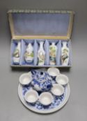 A Chinese blue and white miniature teapot, 6 matching cups and a tray and a box of five vases