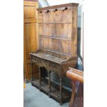 An 18th century style elm pot board dresser with boarded rack, length 132cm, depth 39cm, height