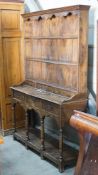 An 18th century style elm pot board dresser with boarded rack, length 132cm, depth 39cm, height