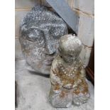 A reconstituted stone Buddha mask garden ornament, height 50cm, together with a seated Buddha garden