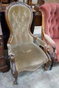 A Victorian carved walnut upholstered spoonback open armchair, width 66cm, depth 72cm, height 98cm