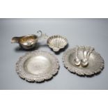 A late Victorian silver butter shell, a later silver sauceboat, seven assorted silver teaspoons