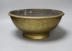 A Himalayan bronze ritual vessel, possibly Tibetan, inscribed 1916 to the interior36cms diameter.