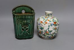 A Chinese famille rose chupu and cover and a Chinese green glazed wall vase, 18 cms high.