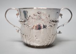 A George I embossed silver porringer, by Thomas Fort, London, 1714, height 91mm, 198 grams, (