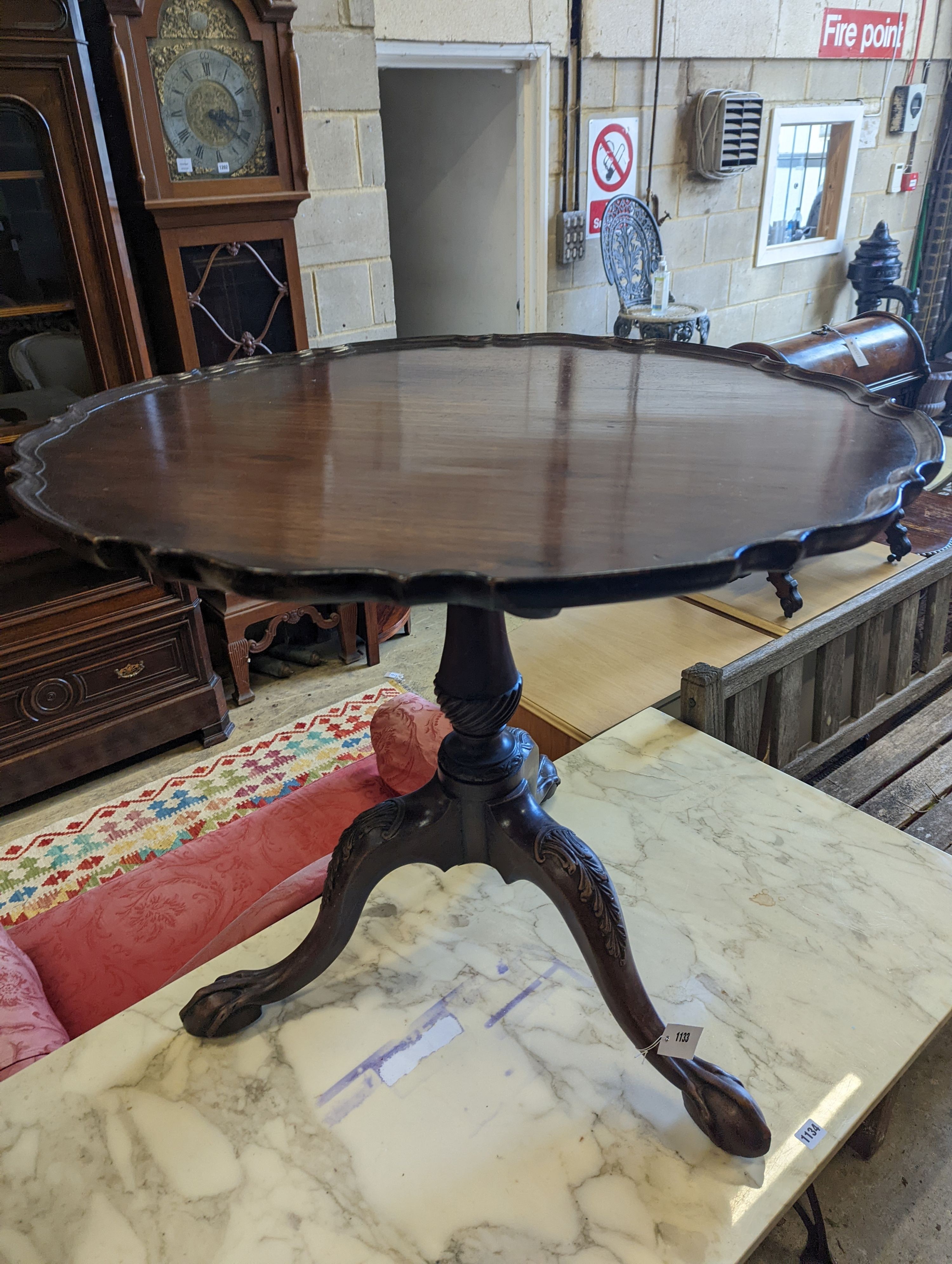 A George III style circular mahogany tripod table, with piecrust top and claw and ball feet, - Image 4 of 6