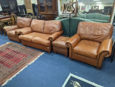 A contemporary tan leather three piece suite and footstool, settee length 150cm, depth 90cm,