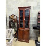 A narrow Victorian mahogany bookcase cupboard, width 71cm, depth 46cm, height 218cm