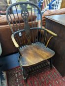 A 19th century elm and beech Windsor wheelback armchair, one leg a replacement, width 51cm, depth