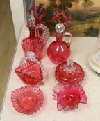 A Victorian cranberry glass decanters, a powder bowl, basket, two vases and two bowls.Tallest