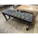 A Jacobean revival carved oak upholstered window seat, width 120cm, depth 29cm, height 40cm