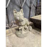 A reconstituted stone garden ornament modelled as a fox with cub, height 42cm