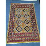 A Caucasian style gold ground rug, 190 x 124cm