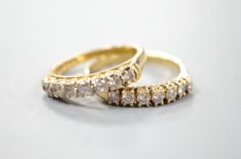 Two modern 18ct gold and seven stone diamond set half eternity rings, sizes M and Q/R, gross 5.9