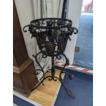 A pair of wrought iron garden planters, no liners, height 81cm