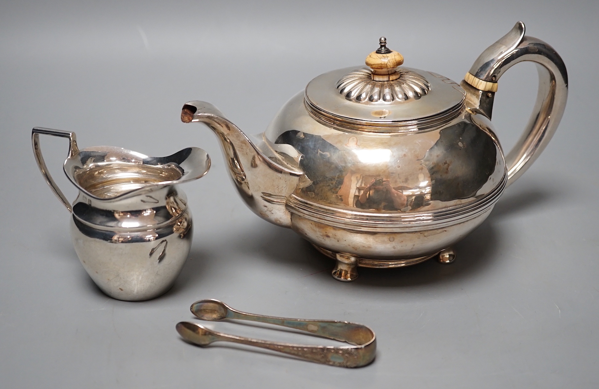 A George IV silver circular teapot, Craddock & Reid, London, 1824, a later silver cream jug and pair