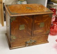 A 19th century oak stationery cabinet with brass mounts,28.5 cms high x 33cms wide.