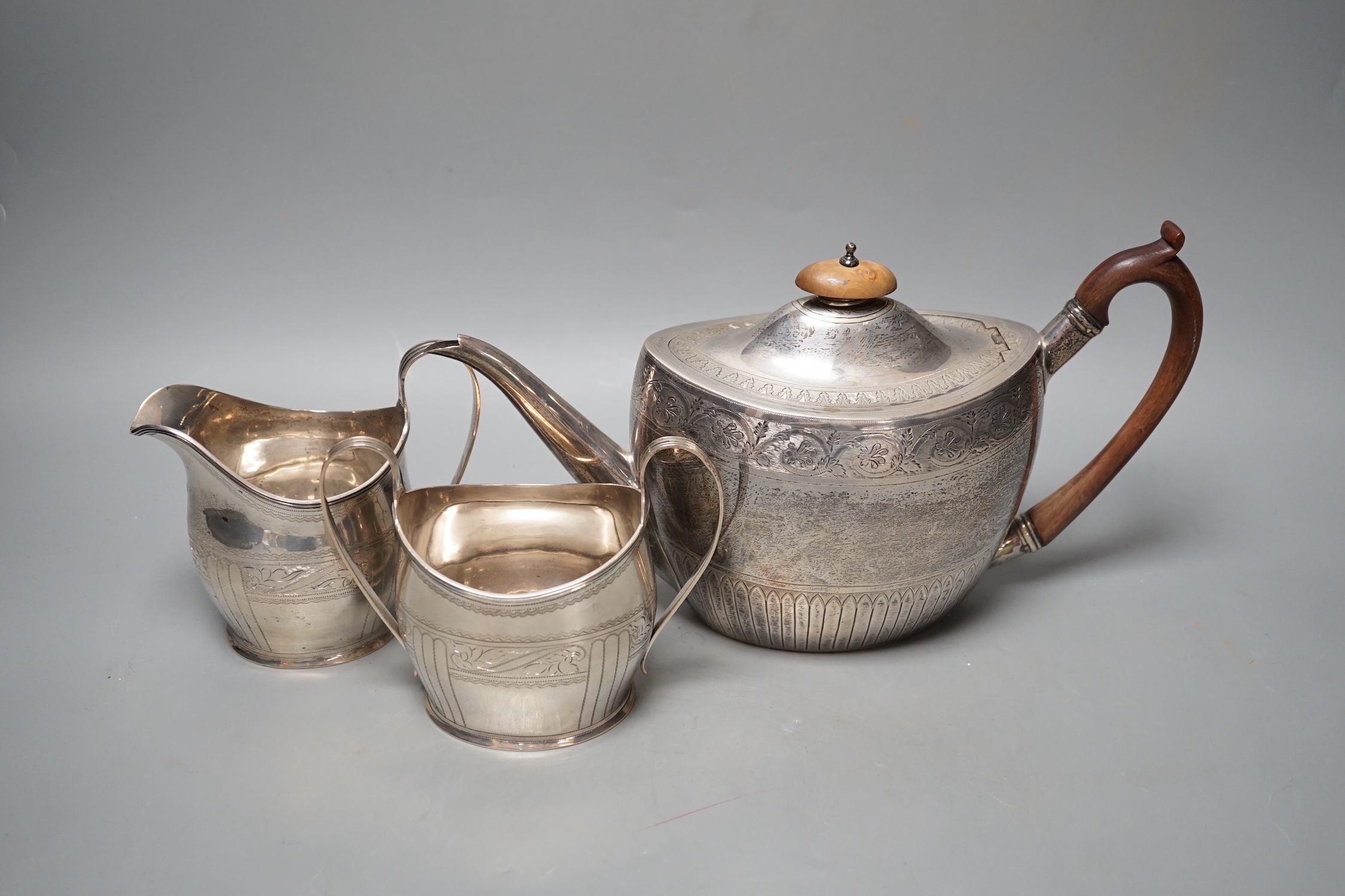 A 1930's engraved silver oval three piece tea set, S. Blanckensee & Sons Ltd, Chester, 1936/7, gross - Image 2 of 4