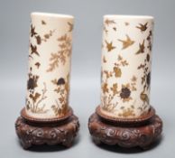 A graduated set of two Japanese gilt lacquered ivory vases, Meiji period, wood stands. Total