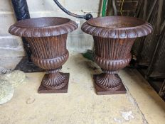A pair of Victorian circular cast iron campana garden urns, diameter 38cm, height 46cm