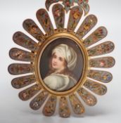An 19th century Paris porcelain portrait miniature of a lady in a champleve enamelled frame. 13.