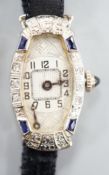 A lady's 18k white metal sapphire and diamond set manual wind cocktail watch, on fabric strap, gross