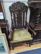 A pair Charles II style carved oak elbow chairs with upholstered seats on turned underframes,