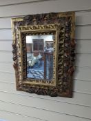 An 18th century painted Italian carved giltwood rectangular wall mirror, width 50cm, height 63cm