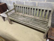 A weathered teak garden bench, length 153cm, depth 50cm, height 79cm and a low square table