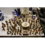 A large collection of Hummel pottery figures, approximately 70 including skier and two similar