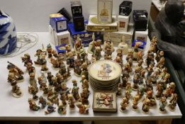 A large collection of Hummel pottery figures, approximately 70 including skier and two similar