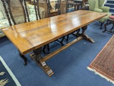 An 18th century style rectangular oak refectory dining table with central stretcher, length 230cm,