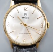 A gentleman's 1970's 9ct gold Tudor manual wind shock-resisting wrist watch, on a black leather