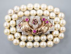 A yellow and white metal, ruby, diamond and cultured pearl cluster set oval brooch, 51mm, gross