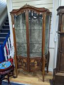 A Louis XV style mahogany serpentine vitrine with Vernis Martin style panels and gilt metal