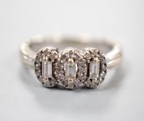 A modern 18ct white gold and diamond set triple cluster ring, size L, gross weight 5.3 grams.