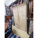 An early 20th century stripped pine two door press cupboard, width 120cm, depth 52cm