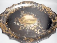 A Victorian papier mache tray, painted with ruins in a landscape - 64cm wide