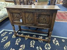 An 18th century style carved oak two door side cabinet, width 107cm, depth 35cm, height 86cm