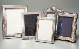 Four assorted modern silver mounted photograph frames, largest 22.2cm and an E.P.N.S. mounted